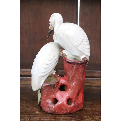 31 - Japanese glazed pottery figure group vase of two cranes (water birds) on a naturalist rouge pierced ... 