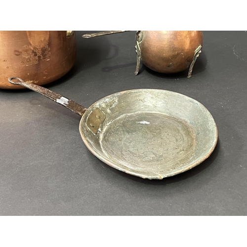 115 - Three copper pieces, lidded saucepan, antique fry pan and footed saucepan (3)