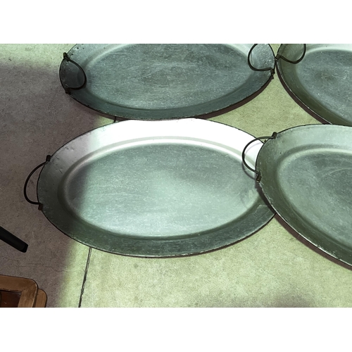 233 - Four oval metal twin handle serving trays, approx 70cm x 45cm each (4)