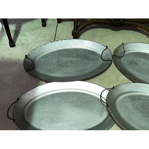 233 - Four oval metal twin handle serving trays, approx 70cm x 45cm each (4)