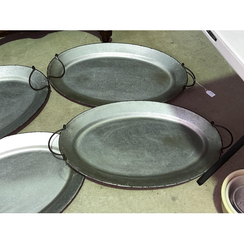 233 - Four oval metal twin handle serving trays, approx 70cm x 45cm each (4)