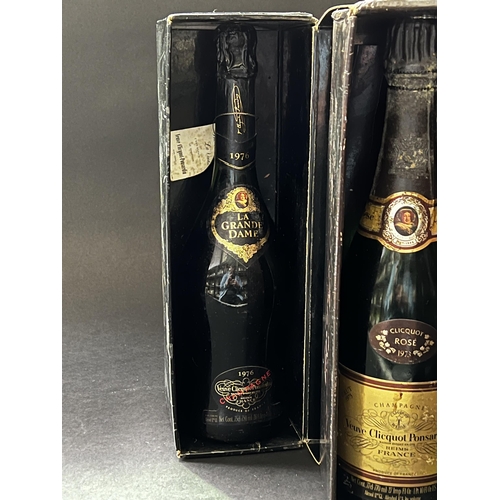 69 - Two bottles of leaking champagne, to be binned (one stuck in box ) (2)