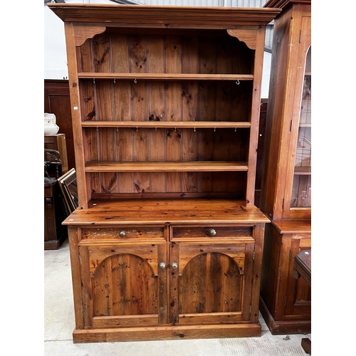 263 - Rustic recycled pine two height open shelf top dresser, fitted with two drawers and two doors below,... 