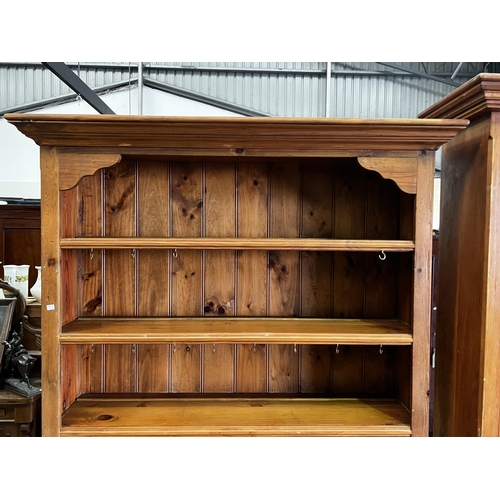 263 - Rustic recycled pine two height open shelf top dresser, fitted with two drawers and two doors below,... 