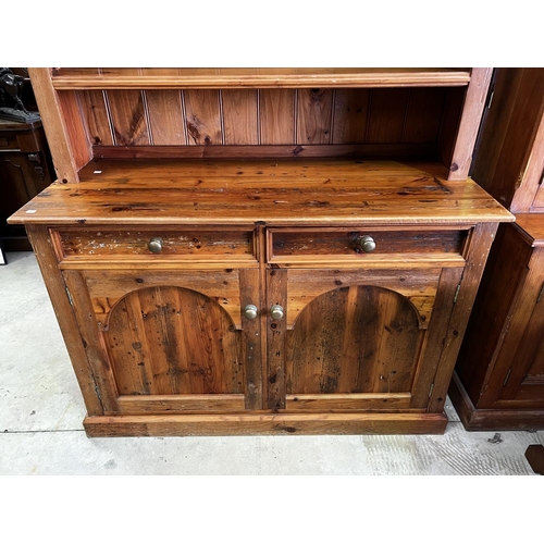 263 - Rustic recycled pine two height open shelf top dresser, fitted with two drawers and two doors below,... 