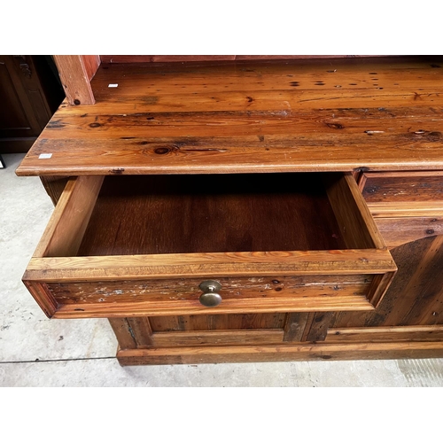 263 - Rustic recycled pine two height open shelf top dresser, fitted with two drawers and two doors below,... 