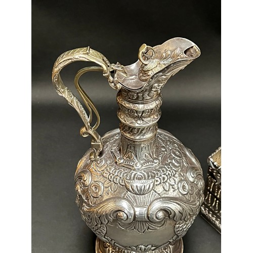 84 - Good quality Barker & Ellis silver plate wine cradle, along with a repousse silver plate claret jug ... 