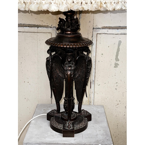 29 - Large bronze oil lamp base, three winged griffons support on a tri form base, approx 88cm H