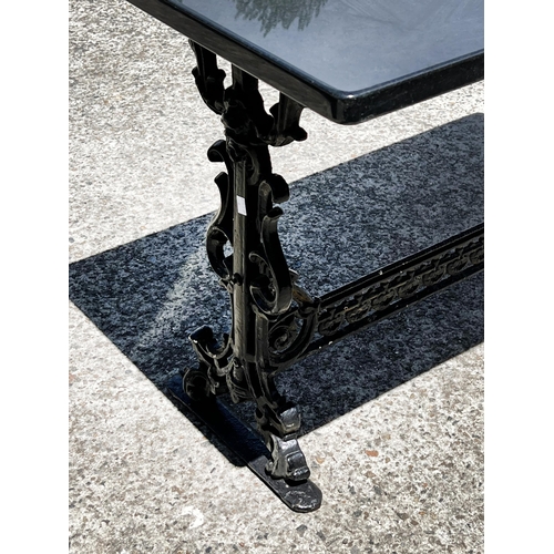 39 - Antique cast iron support marble topped garden table, approx 70cm H x 110cm W x 60cm D