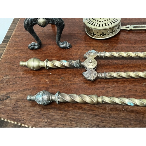 59 - French brass fire tools, brass chestnut roaster, and pair of  brass and iron fire dogs