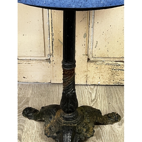 75 - French cast iron based café table, blue stained composite granite top, approx 73cm H x 60cm Dia