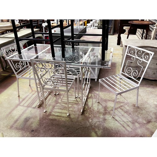 136 - Vintage iron white painted patio suite, comprising a glass topped table and four chairs table, appro... 