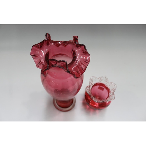 63 - Two cranberry glass vases, approx 28cm H and shorter (2)