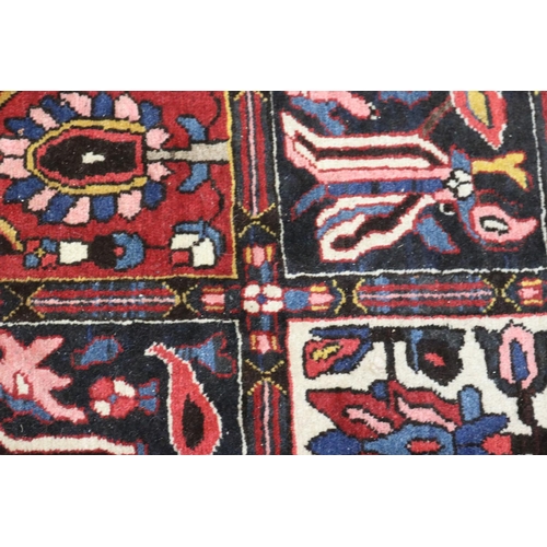 1147 - Old hand knotted carpet of red ground, approx 206cm x 310cm