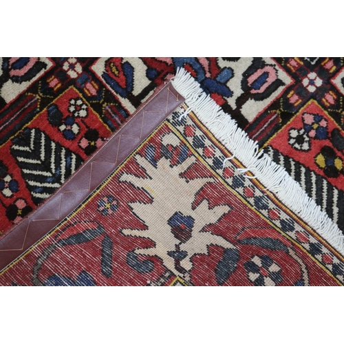 1147 - Old hand knotted carpet of red ground, approx 206cm x 310cm