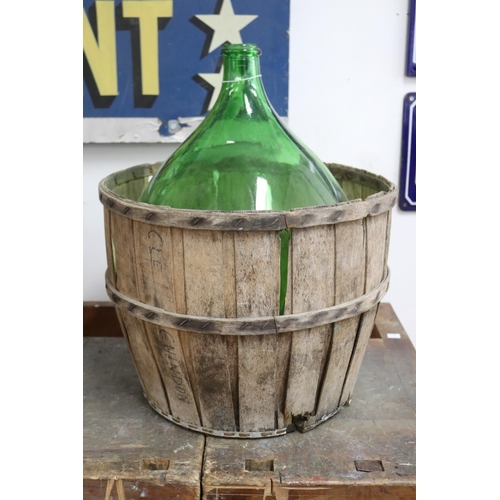1124 - French green glass bottle in bentwood cradle, approx 53cm H x 44cm Dia