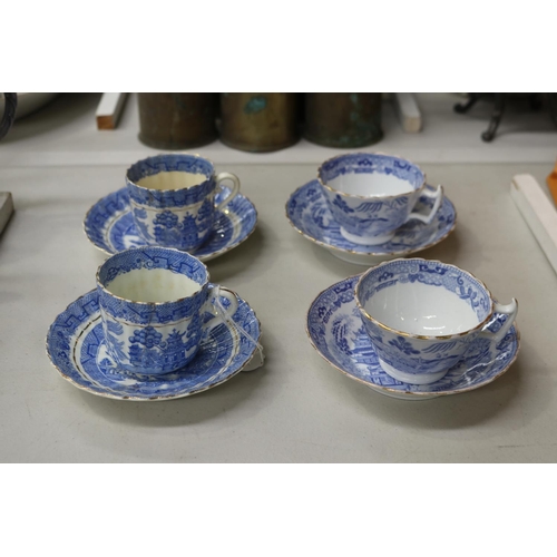 155 - Four antique blue and white Willow pattern teacups and saucers