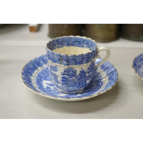 155 - Four antique blue and white Willow pattern teacups and saucers