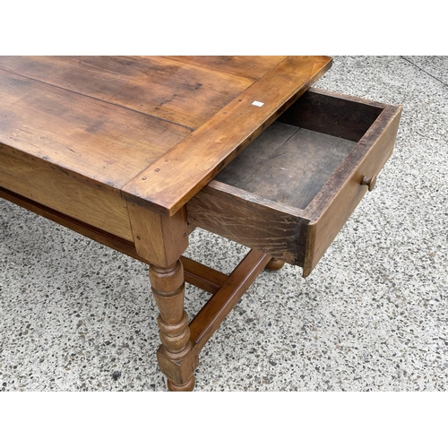 169 - Antique French turned leg country table, with central stretcher, deep single drawer at each end, app... 