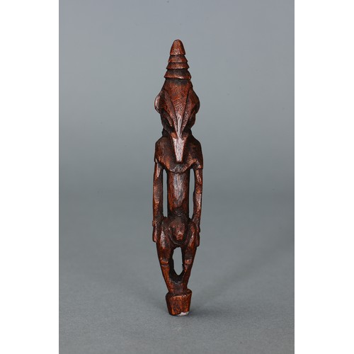 56 - Fine and small Ramu Amulet, Papua New Guinea. Carved and engraved hardwood. Diminutive in size, this... 