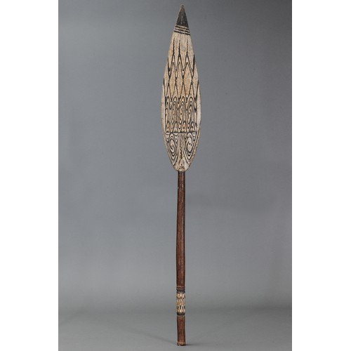73 - Lake Sentani Dance Paddle with face on blade, Papua New Guinea. Carved and engraved hardwood and nat... 