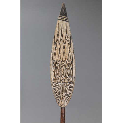 73 - Lake Sentani Dance Paddle with face on blade, Papua New Guinea. Carved and engraved hardwood and nat... 