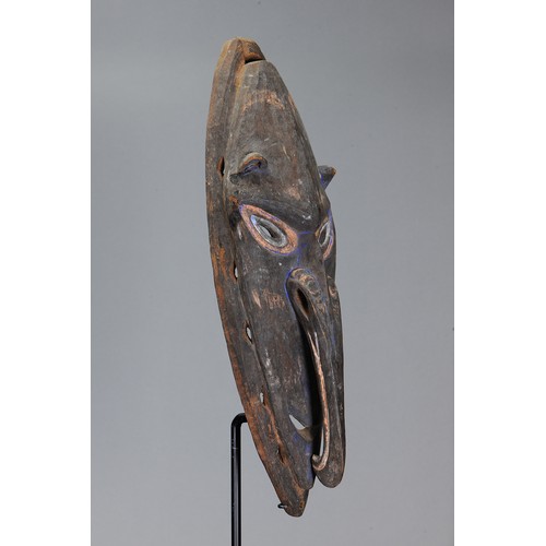 86 - Early Sepik Mask, Papua New Guinea. Carved and engraved hardwood and natural pigment. Approx L58.5 x... 
