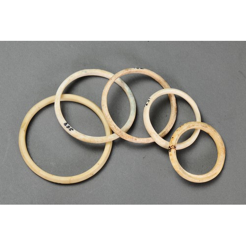 139 - A Collection of Five arm rings, Solomon Islands. Carved tridacna clam shell. Approx Lengths 9.5cm to... 