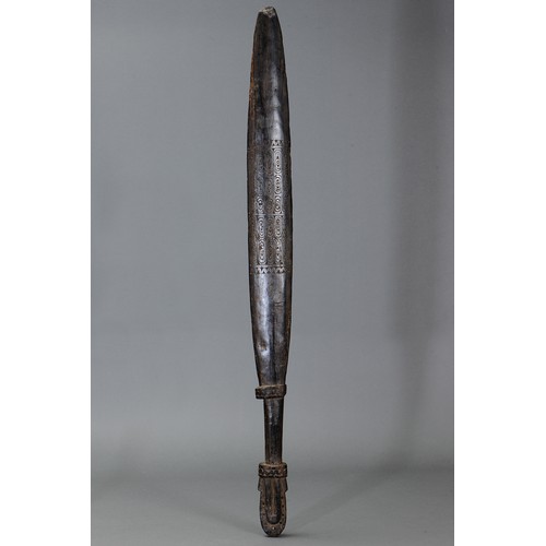 251 - Large Massim Club, Trobriand Islands, Papua New Guinea. Carved and engraved hardwood and natural pig... 