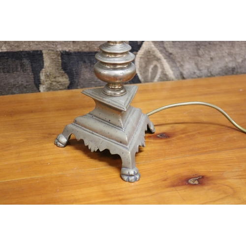 1240 - Bronze tri footed pricket converted into a lamp, unknown working order, needs rewiring, approx 45cm ... 