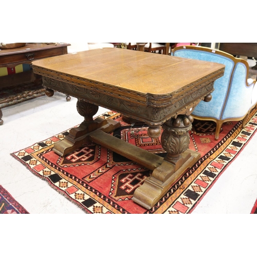 1250 - Antique English oak extension dining table, held with large carved baluster supports, with central f... 