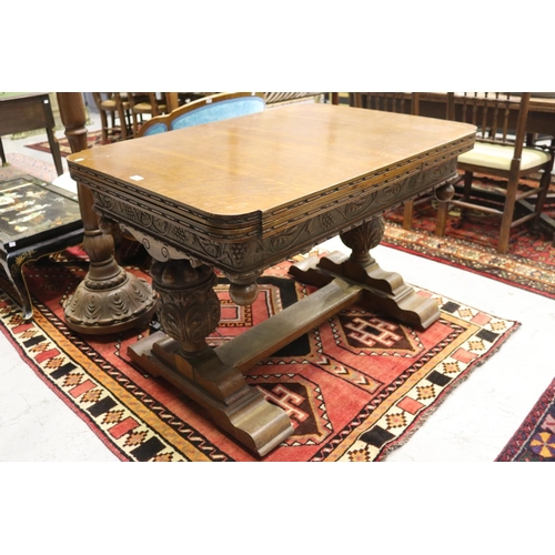 1250 - Antique English oak extension dining table, held with large carved baluster supports, with central f... 