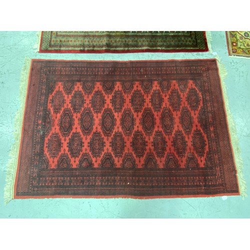 1254 - Handwoven wool carpet of red ground, approx 124cm x 196cm