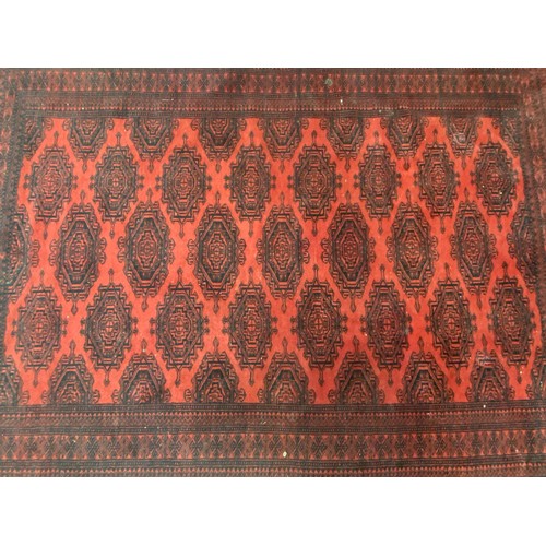 1254 - Handwoven wool carpet of red ground, approx 124cm x 196cm