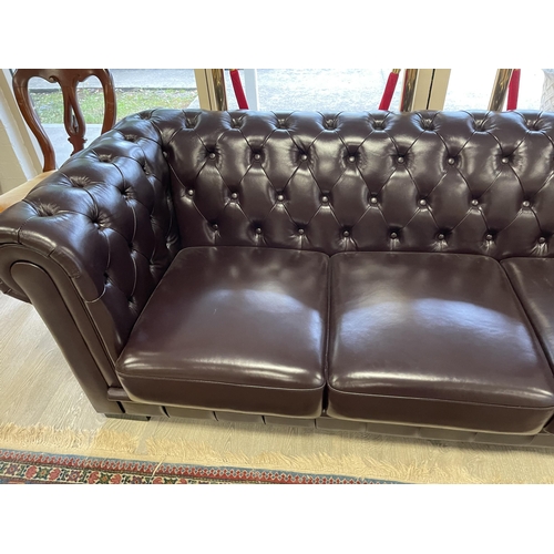 191 - Dark chocolate brown deep buttoned leather three seater Chesterfield, approx 212cm W