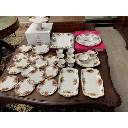 258 - Assortment of Royal Albert Country Roses, to include trays, cups, bread plates, comport etc