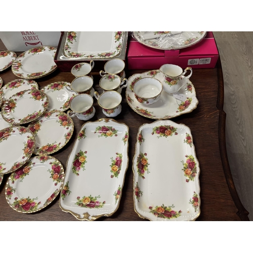 258 - Assortment of Royal Albert Country Roses, to include trays, cups, bread plates, comport etc