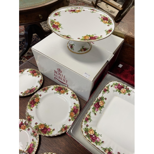 258 - Assortment of Royal Albert Country Roses, to include trays, cups, bread plates, comport etc