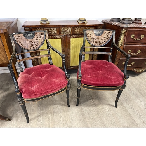 10 - Pair of Regency style ebonized caned armchairs with loose button cushions. (one seat cane is damaged... 