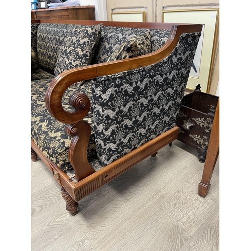 13 - Antique walnut three seater settee, unusual design, with double scroll arm supports, carved applied ... 