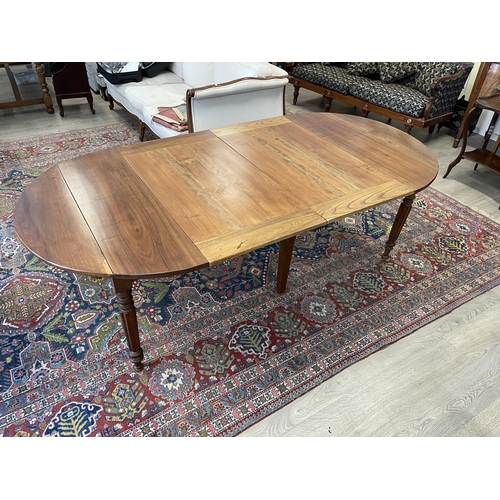 17 - Antique French turned fluted leg extension dining table, with two extra leaves, approx 232 cm long (... 