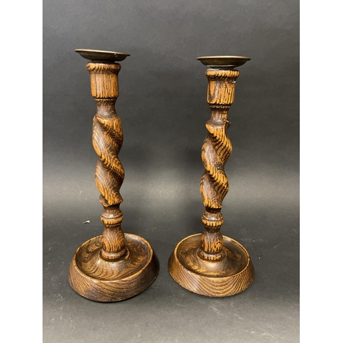 93 - Pair of English oak barley twist candlesticks, brass drip pans (2)