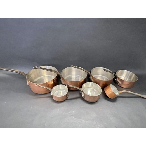 97 - Good set of eight French (Tournus) copper saucepans of graduating size, to include a long handled sa... 