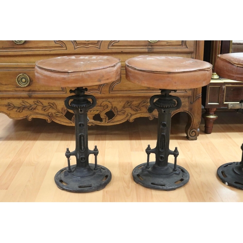 1016 - Set of four leather topped cast iron base stools, the leather seats marked Paris, industrial style, ... 