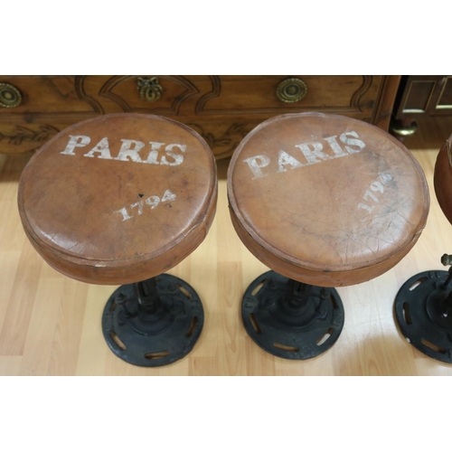 1016 - Set of four leather topped cast iron base stools, the leather seats marked Paris, industrial style, ... 
