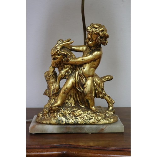 1135 - Figural gilt putto with goat lamp on marble base, with shade, working at time of inspection, approx ... 