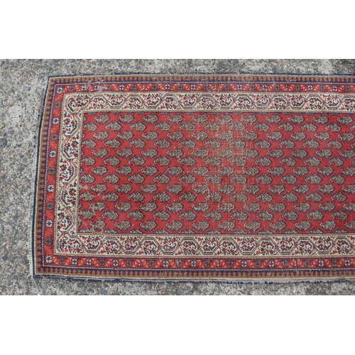 1157 - Persian handwoven wool carpet of red ground, multi borders to edge, approx 88cm x 159cm