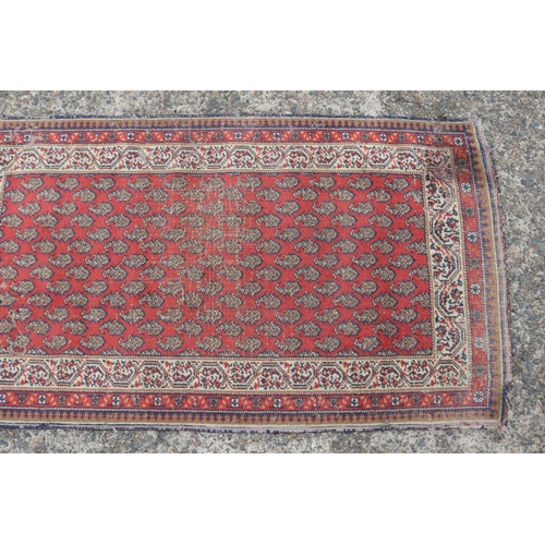 1157 - Persian handwoven wool carpet of red ground, multi borders to edge, approx 88cm x 159cm