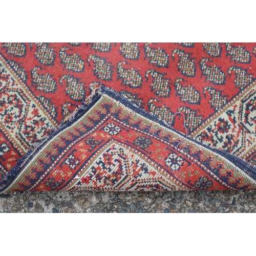 1157 - Persian handwoven wool carpet of red ground, multi borders to edge, approx 88cm x 159cm