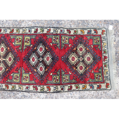 1158 - Persian handwoven wool carpet of red ground with three gulls to centre, 52cm x 107cm